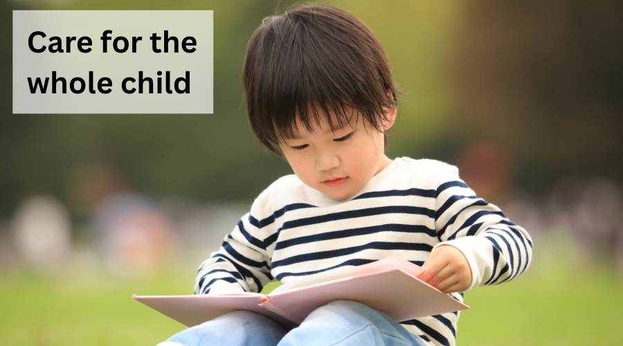 a child sits in the grass and reads a book. Text says "care for the whole child."